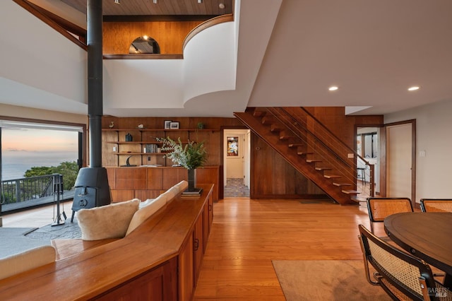 272 Ocean Pkwy, Bolinas, CA 94924 - living room featuring a wood stove, stairway, light wood-type flooring, recessed lighting, and wood walls