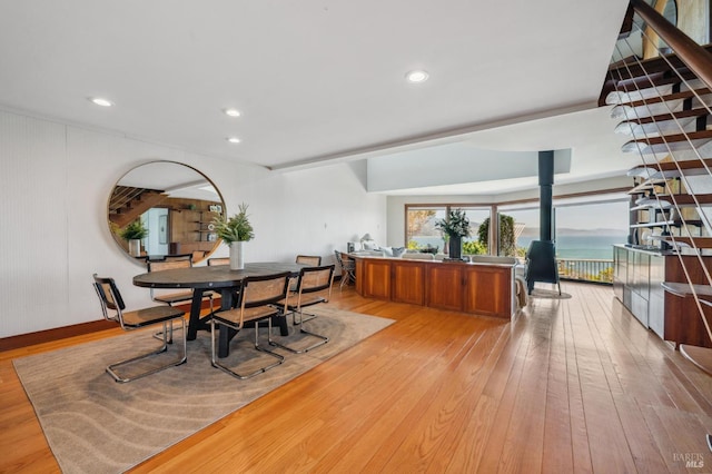 272 Ocean Pkwy, Bolinas, CA 94924 - dining space featuring light wood-style flooring, a wood stove, recessed lighting, and stairs