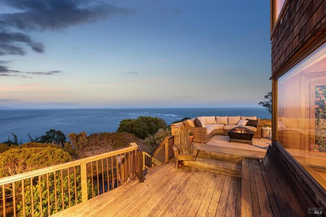 272 Ocean Pkwy, Bolinas, CA 94924 - deck at dusk with an outdoor fire pit and a water view