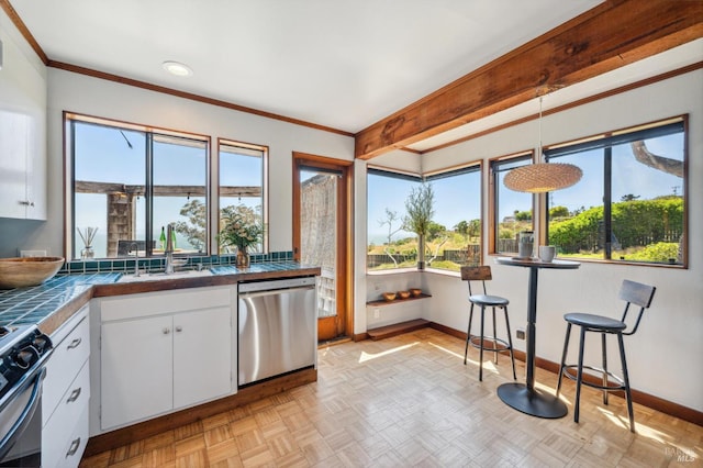 272 Ocean Pkwy, Bolinas, CA 94924 - kitchen with appliances with stainless steel finishes, white cabinets, plenty of natural light, tile countertops, and crown molding