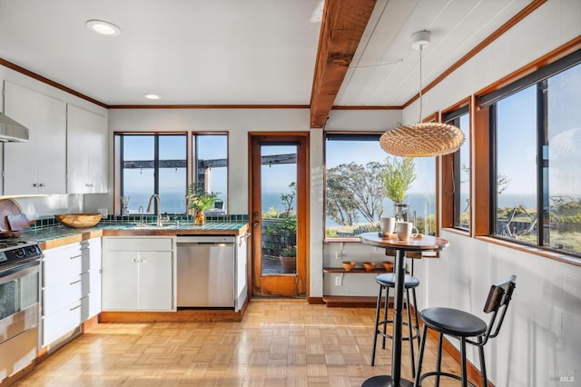 272 Ocean Pkwy, Bolinas, CA 94924 - kitchen with stainless steel appliances, white cabinetry, tile counters, crown molding, and recessed lighting