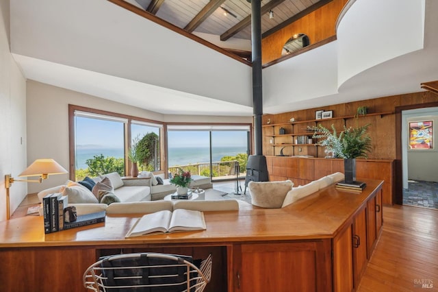 272 Ocean Pkwy, Bolinas, CA 94924 - living room with a wood stove, wood finished floors, a towering ceiling, a wood ceiling with exposed beams, and wood walls