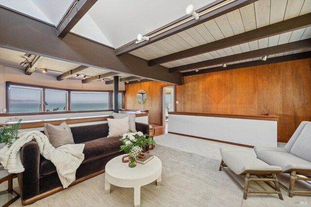 272 Ocean Pkwy, Bolinas, CA 94924 - living area with track lighting, wooden walls, a water view, a wooden ceiling with exposed beams, and carpet