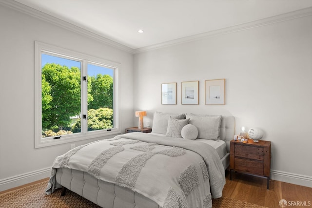 bedroom featuring wood-type flooring and crown molding