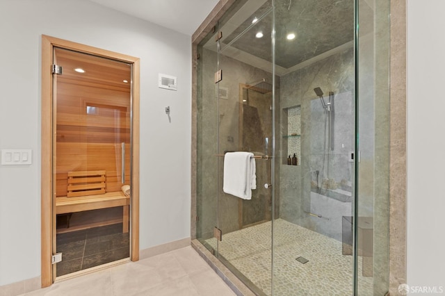 bathroom featuring a shower with door and tile patterned floors