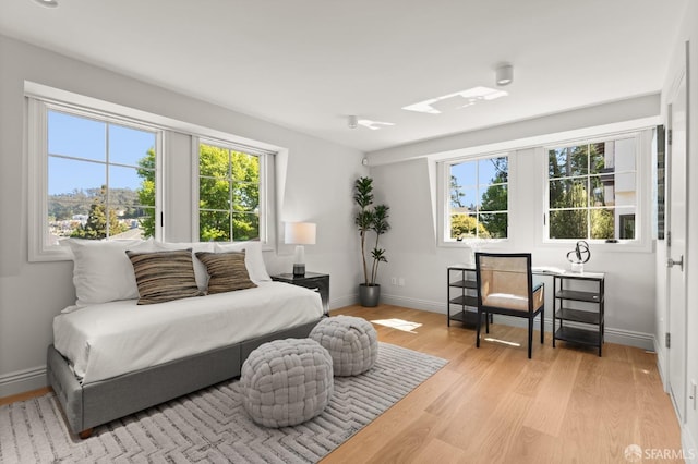 living room with light wood-type flooring and plenty of natural light