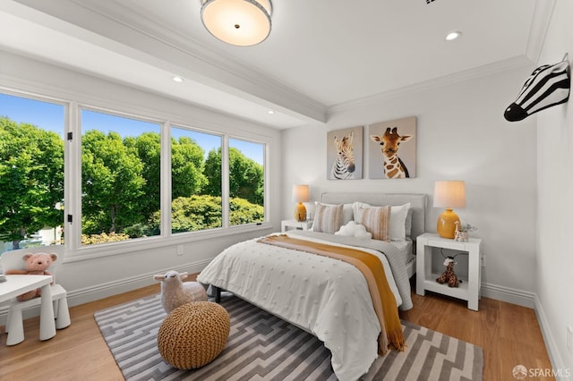 bedroom with light wood-type flooring and ornamental molding