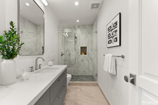 bathroom with vanity, a shower with shower door, and toilet