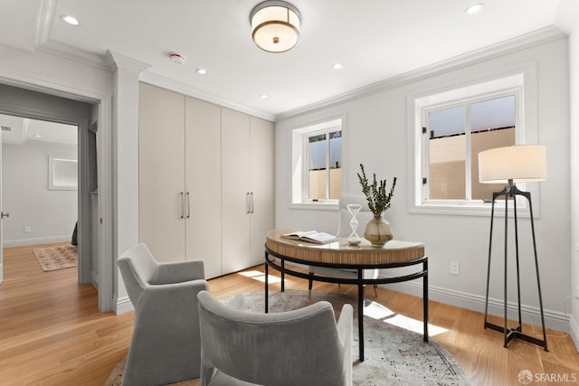 home office featuring light wood-type flooring and ornamental molding