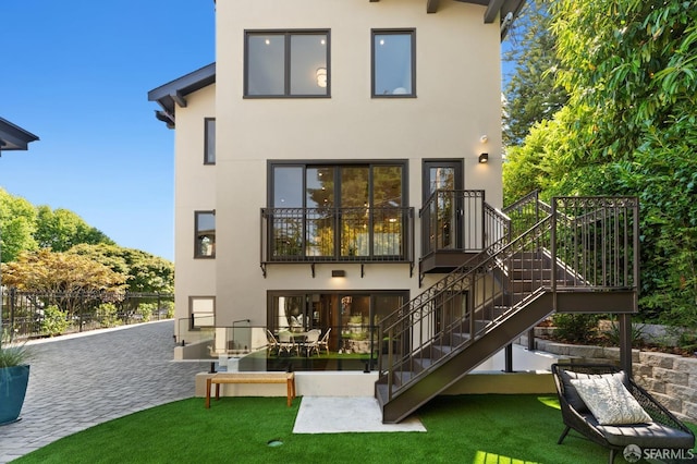 back of house with a patio area and a yard