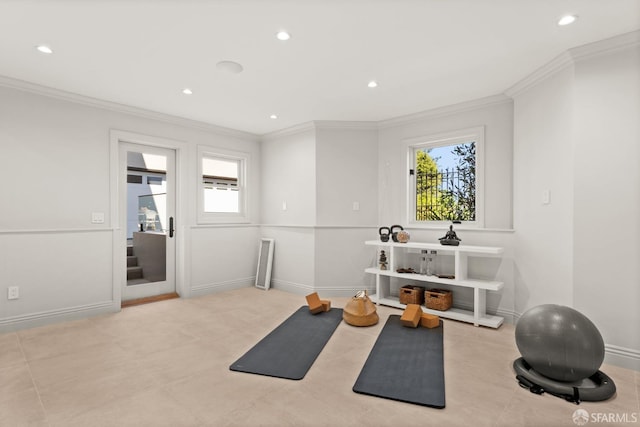 workout room with ornamental molding and a wealth of natural light