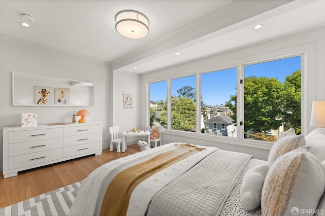 bedroom featuring light hardwood / wood-style flooring and crown molding