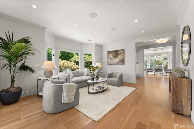 living room with crown molding, light hardwood / wood-style flooring, and plenty of natural light