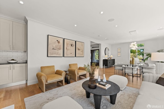 living room featuring light wood-type flooring and crown molding