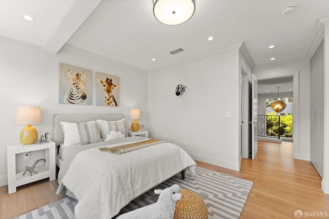 bedroom with beamed ceiling, light hardwood / wood-style flooring, and crown molding