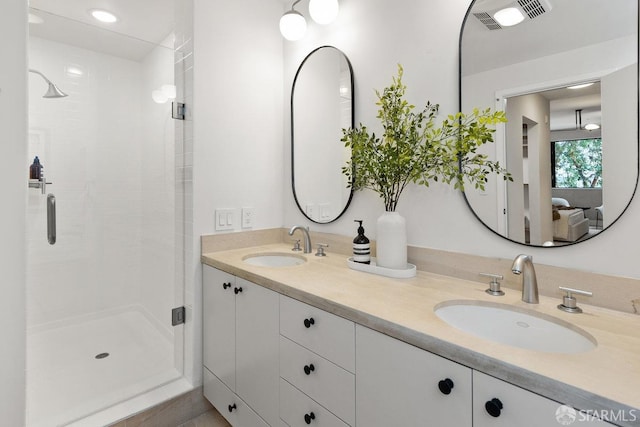 bathroom featuring vanity and a shower with shower door