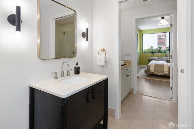 bathroom featuring hardwood / wood-style flooring, vanity, and a shower