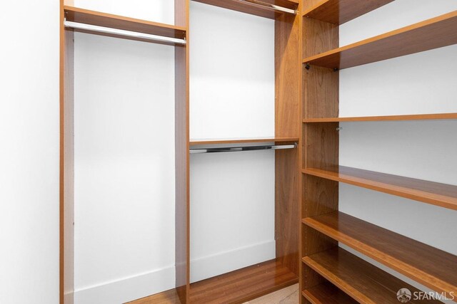 spacious closet featuring hardwood / wood-style flooring