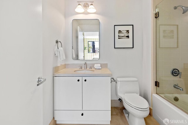 full bathroom featuring bath / shower combo with glass door, vanity, toilet, and tile patterned floors