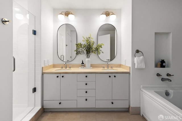 bathroom featuring tile patterned flooring, independent shower and bath, and vanity