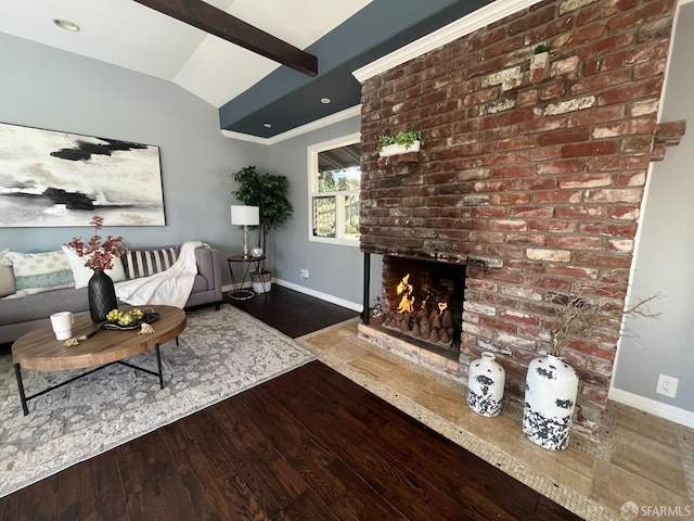 living room with lofted ceiling with beams, ornamental molding, dark wood-type flooring, and a fireplace