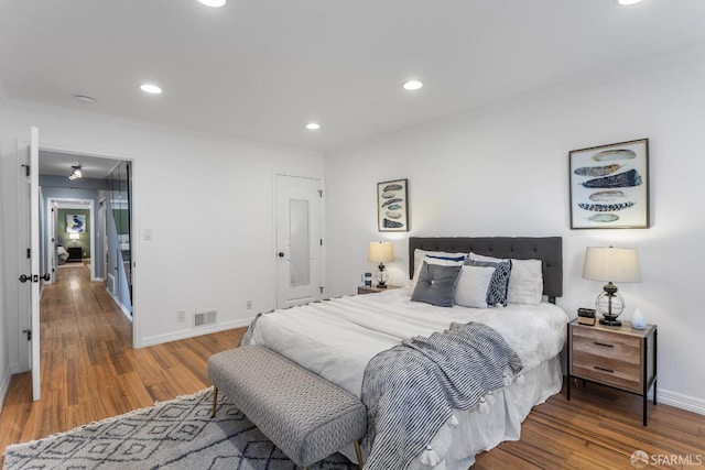 bedroom featuring dark hardwood / wood-style flooring and crown molding