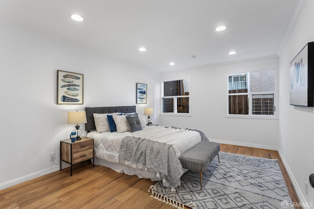 bedroom with crown molding and hardwood / wood-style flooring