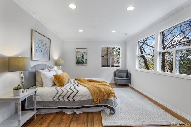 bedroom with hardwood / wood-style flooring and crown molding