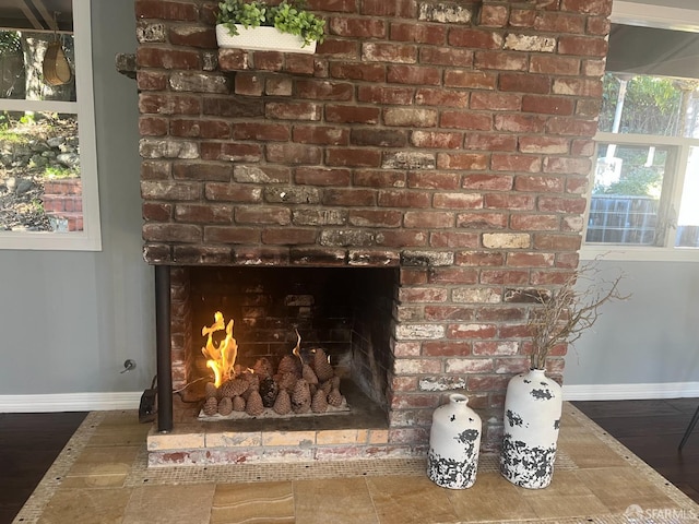 room details with a brick fireplace and wood-type flooring