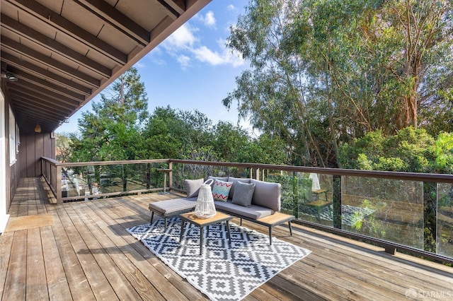 wooden deck with an outdoor living space