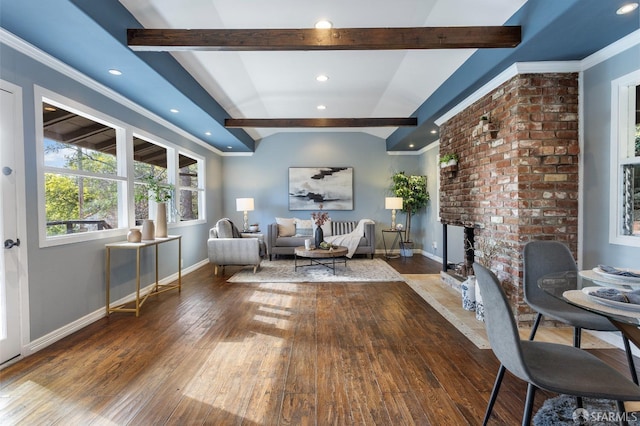 interior space featuring crown molding, a fireplace, hardwood / wood-style floors, and vaulted ceiling with beams