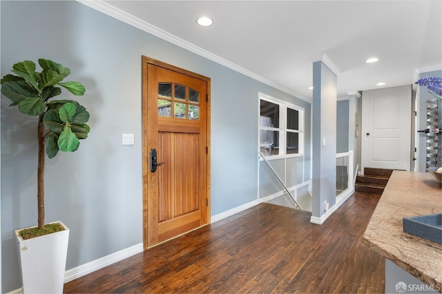 entrance foyer featuring dark wood-type flooring and crown molding