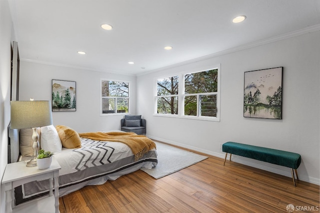 bedroom with hardwood / wood-style flooring and ornamental molding