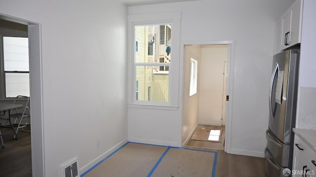 doorway featuring visible vents, baseboards, and dark wood-type flooring