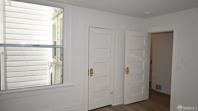 interior space featuring wood finished floors and visible vents