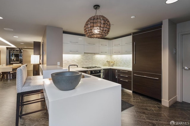 420 Mission Bay Blvd Unit 708, San Francisco, CA 94158 - kitchen with white cabinetry, decorative backsplash, modern cabinets, a peninsula, and dark wood-style flooring