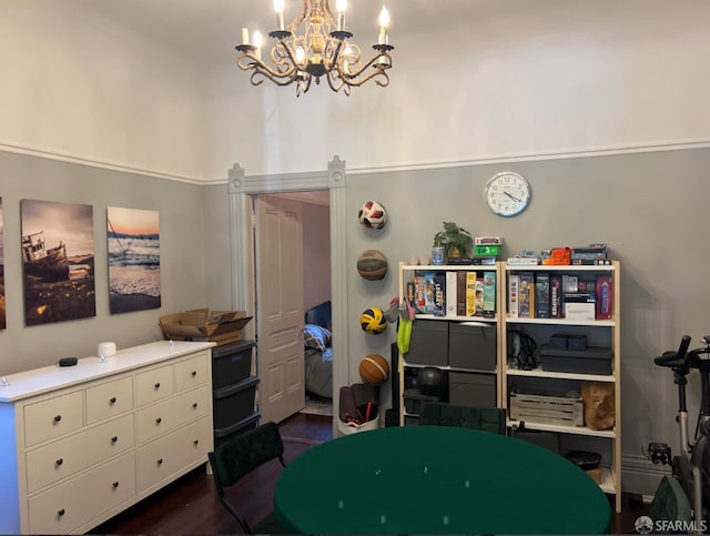 recreation room featuring dark wood-type flooring and a chandelier