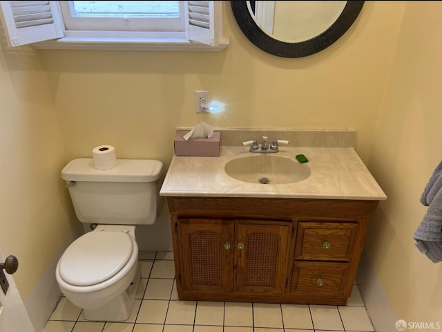 bathroom featuring tile patterned floors, vanity, toilet, and a skylight