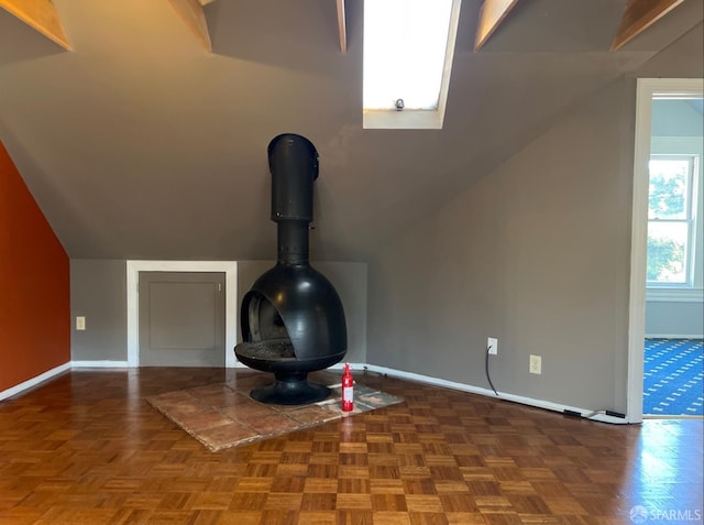 interior details featuring parquet flooring, a wood stove, and a skylight