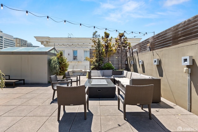 view of patio / terrace with an outdoor living space with a fire pit