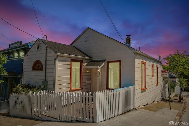 99 Manchester St, San Francisco, CA 94110 - view of front of property with a fenced front yard, a chimney, and roof with shingles