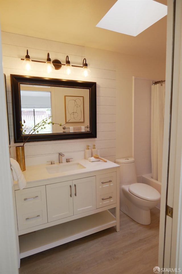 539 Pimlico Ct, Walnut Creek, CA 94597 - full bathroom with a skylight, vanity, wood finished floors, toilet, and shower / bath combination with curtain
