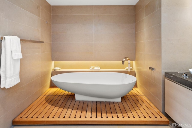 bathroom with a washtub and tile walls