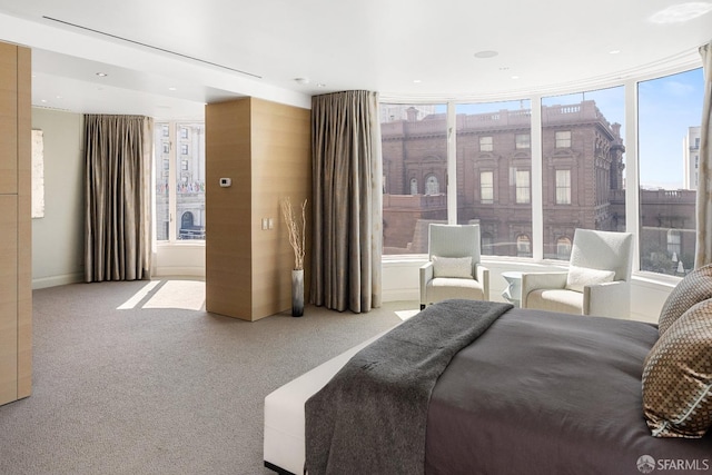 bedroom featuring light colored carpet and multiple windows