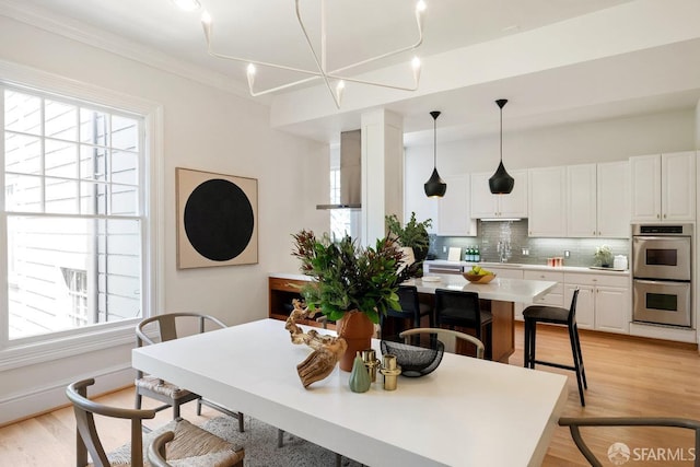 2864 Sacramento St, San Francisco, CA 94115 - dining room featuring light wood-style floors and crown molding