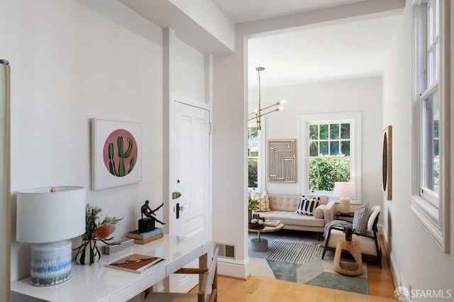 2864 Sacramento St, San Francisco, CA 94115 - corridor featuring wood finished floors, a chandelier, and baseboards