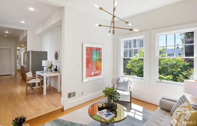 2864 Sacramento St, San Francisco, CA 94115 - living area with light wood-style flooring, a chandelier, and recessed lighting