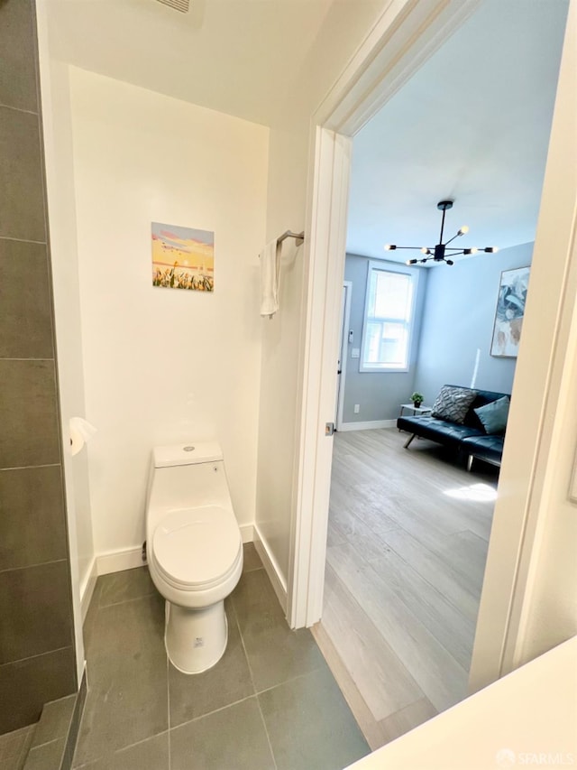 bathroom featuring toilet, ceiling fan, and tile patterned flooring