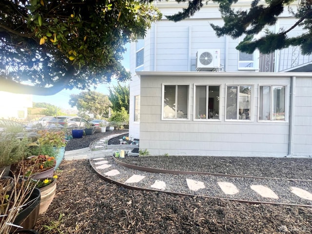 view of side of home featuring ac unit