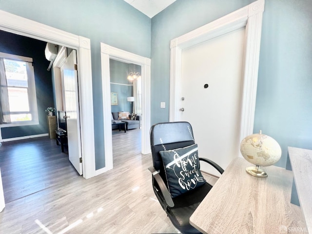 office area featuring a wall mounted AC and light hardwood / wood-style floors